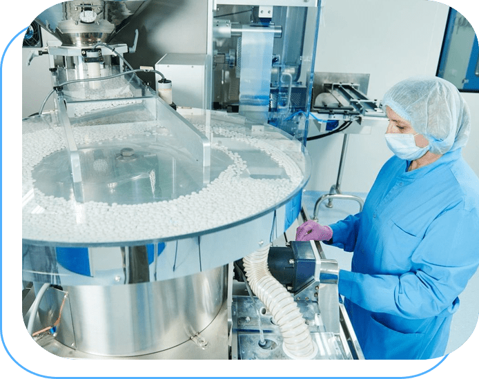 A person in blue lab coat and mask working on machine.